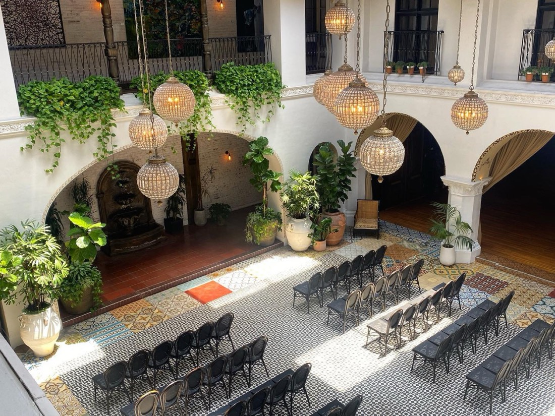Plants installed around a historic Pasadena-style courtyard venue set up for an event