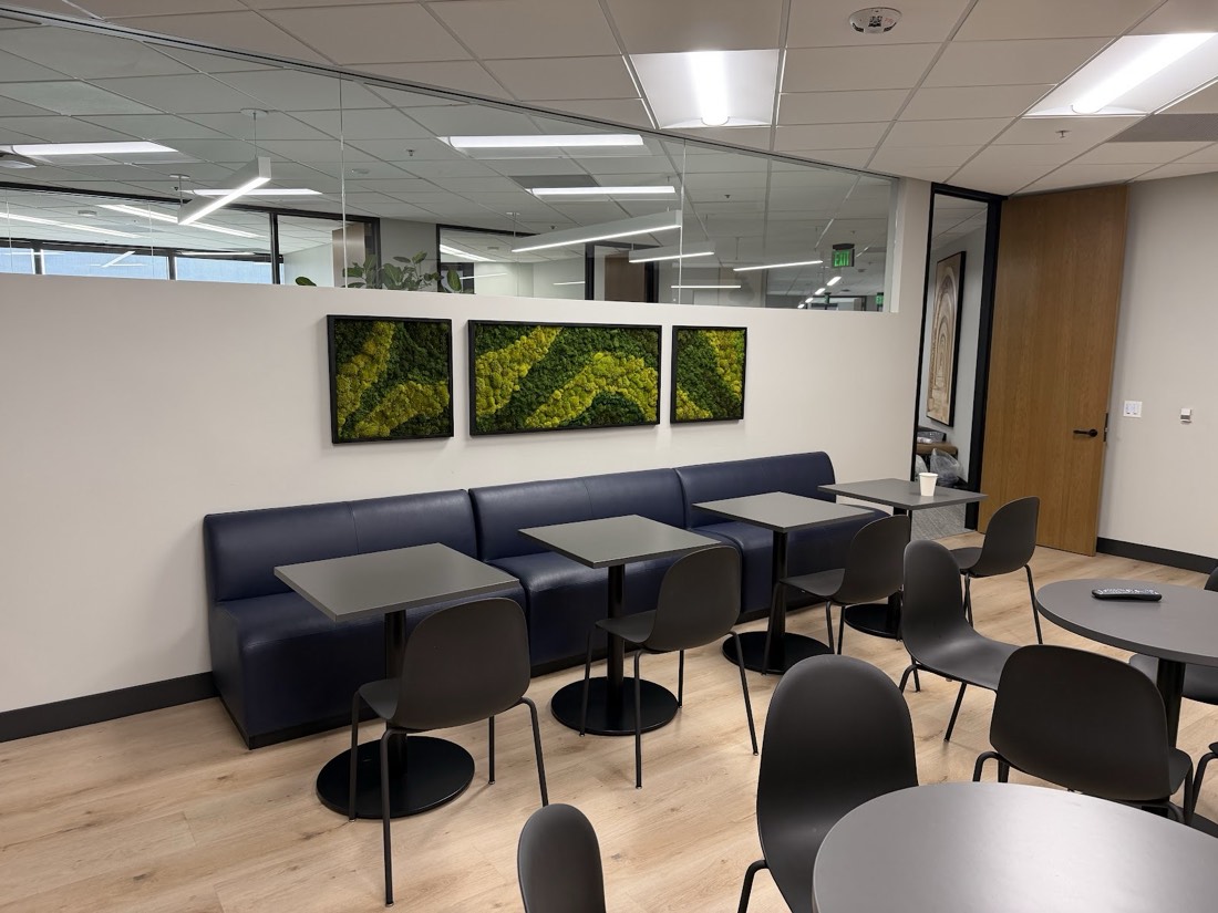 Three preserved moss art panels above an office banquette