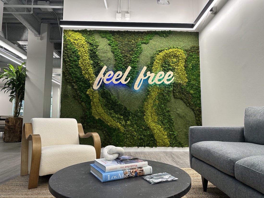 Preserved moss wall with 'feel free' logo in an office lounge