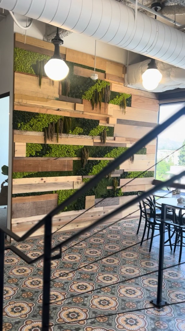 Preserved moss set between reclaimed wood slats in a restaurant