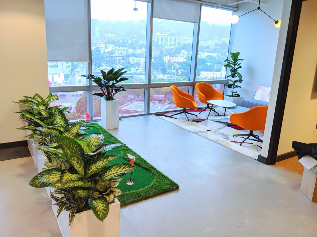 White planter boxes and greenery in a Los Angeles office overlooking the Hollywood Hills